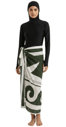 Olive green linen pareo long sarong wrap styled over modest swimwear for elegant beach coverage.